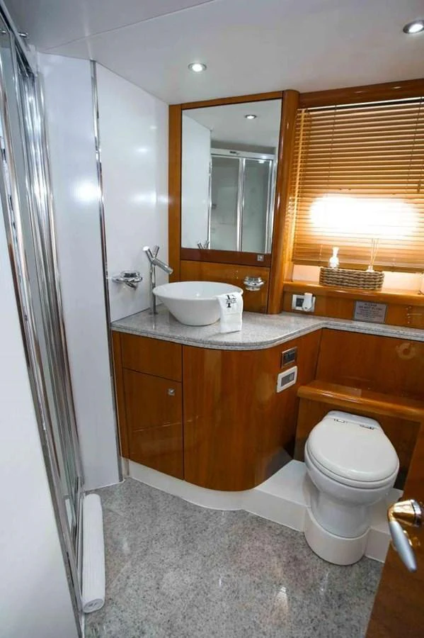 The yacht's bathroom features modern fixtures and a sleek design. aboard 2006 SUNSEEKER MANHATTAN 'FINS UP' Yacht for Sale