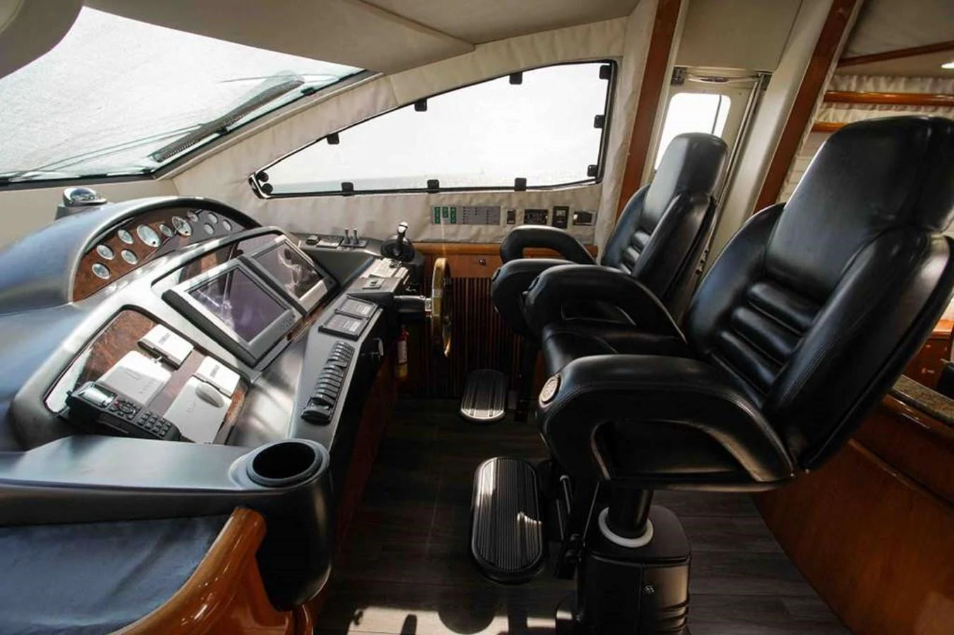 The helm station features luxurious leather seating and advanced navigation equipment. aboard 2006 SUNSEEKER MANHATTAN 'FINS UP' Yacht for Sale