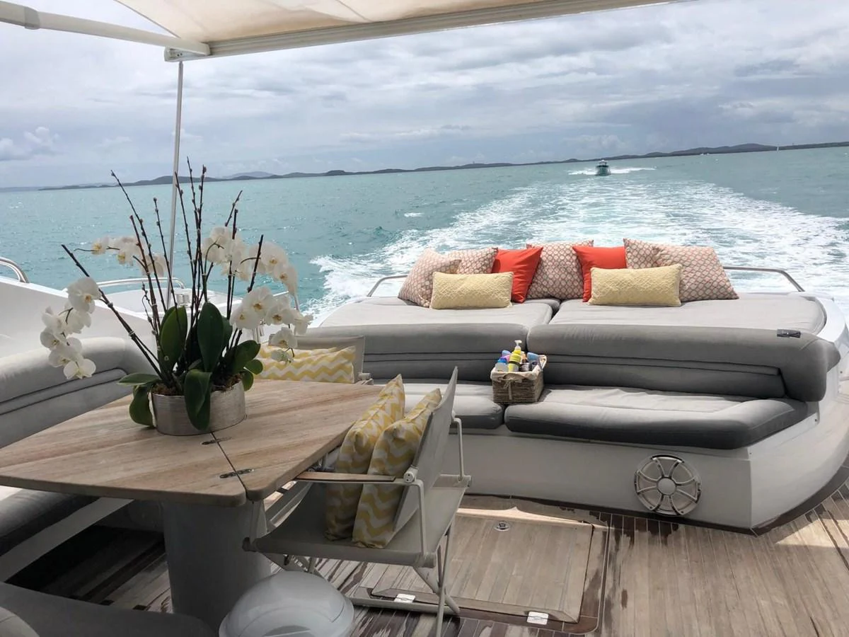 a white couch and a table with a plant on it aboard GBXSK03391E506 Yacht for Sale