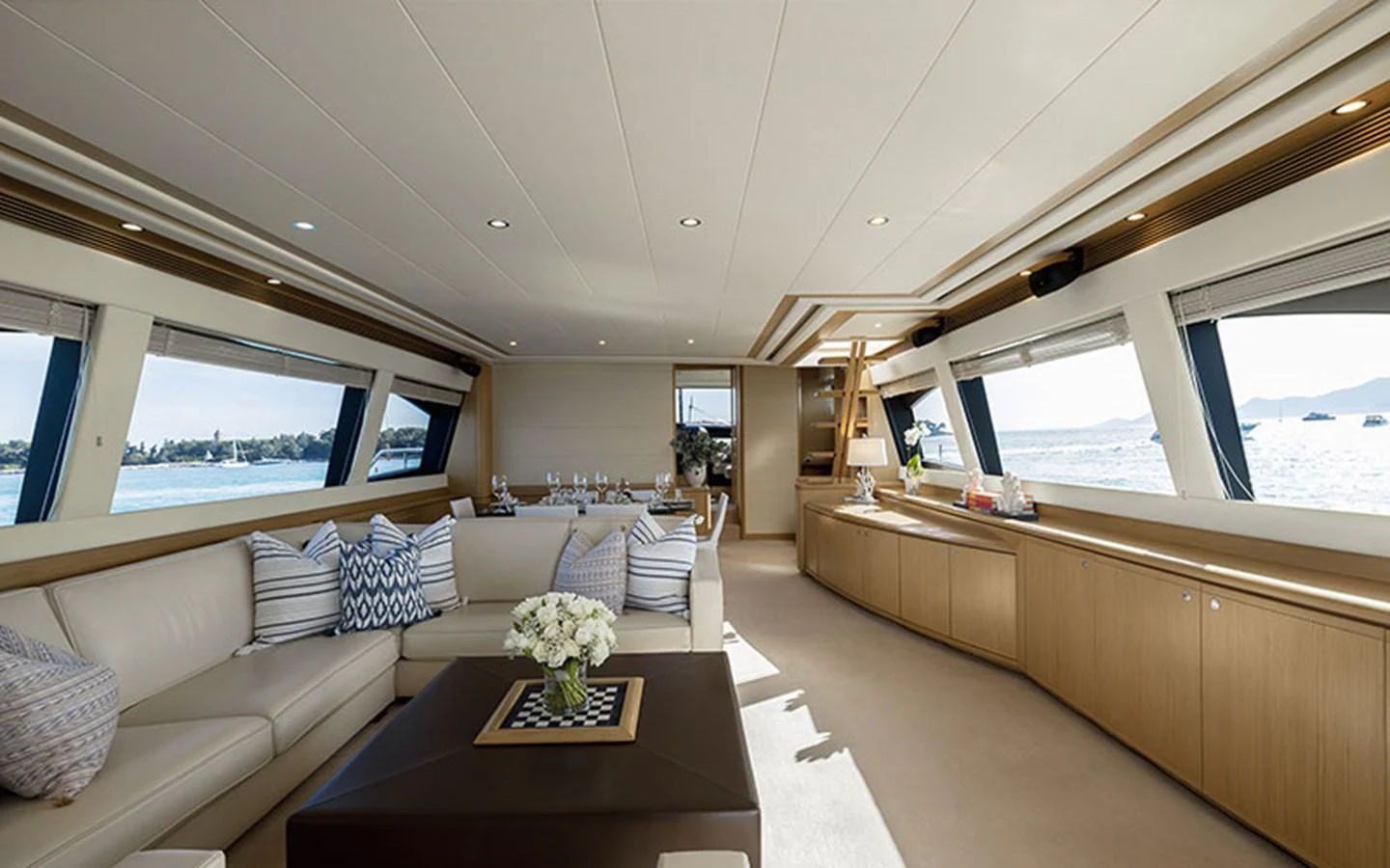 The spacious salon features elegant seating and panoramic windows offering stunning sea views. aboard ONYX Yacht for Sale