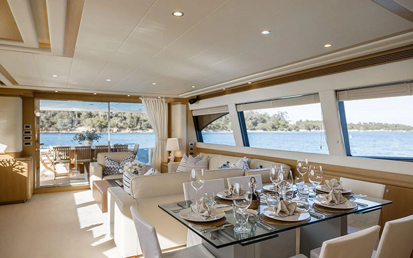 The yacht's salon is elegantly designed with a spacious dining area and large windows offering stunning sea views. aboard ONYX Yacht for Sale