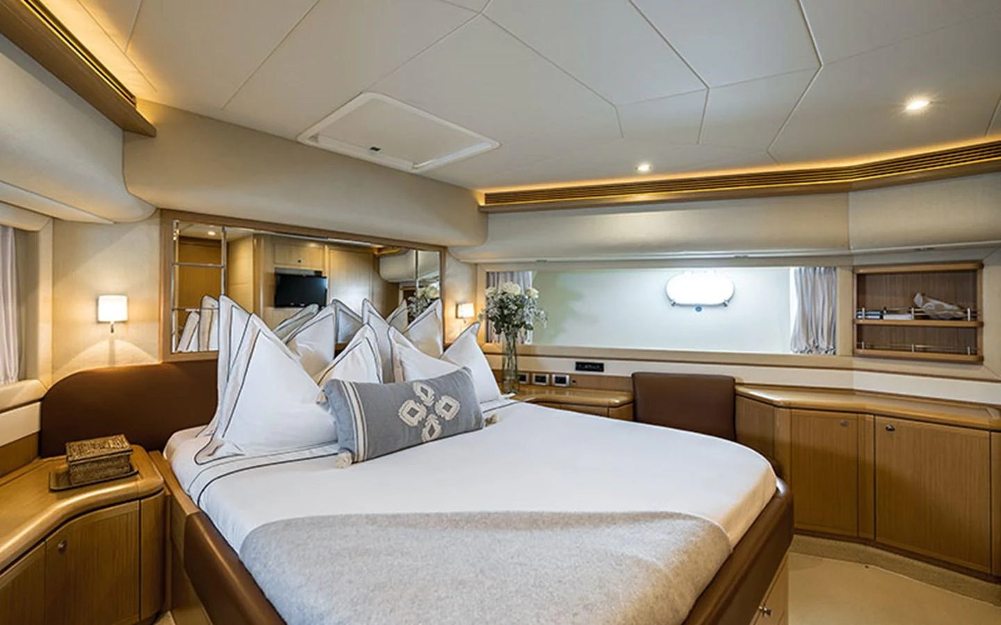 The stateroom features a luxurious bed with elegant bedding and ample natural light. aboard ONYX Yacht for Sale