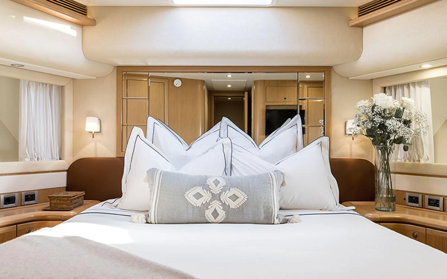 The master stateroom features a luxurious bed with plush pillows and elegant decor. aboard ONYX Yacht for Sale
