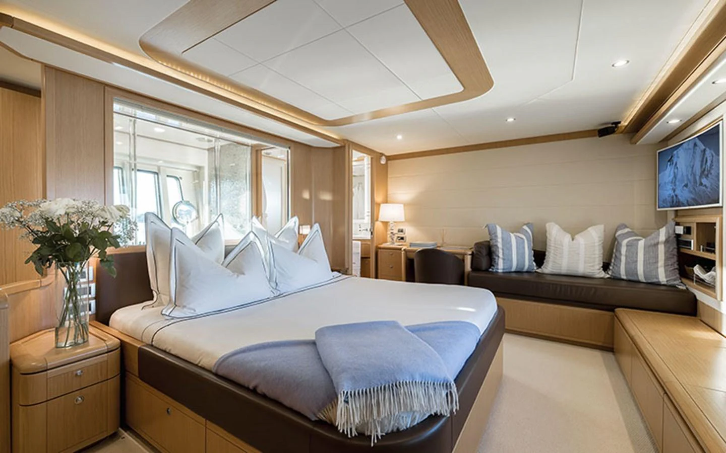 The master stateroom features a spacious bed, cozy seating area, and elegant decor. aboard ONYX Yacht for Sale