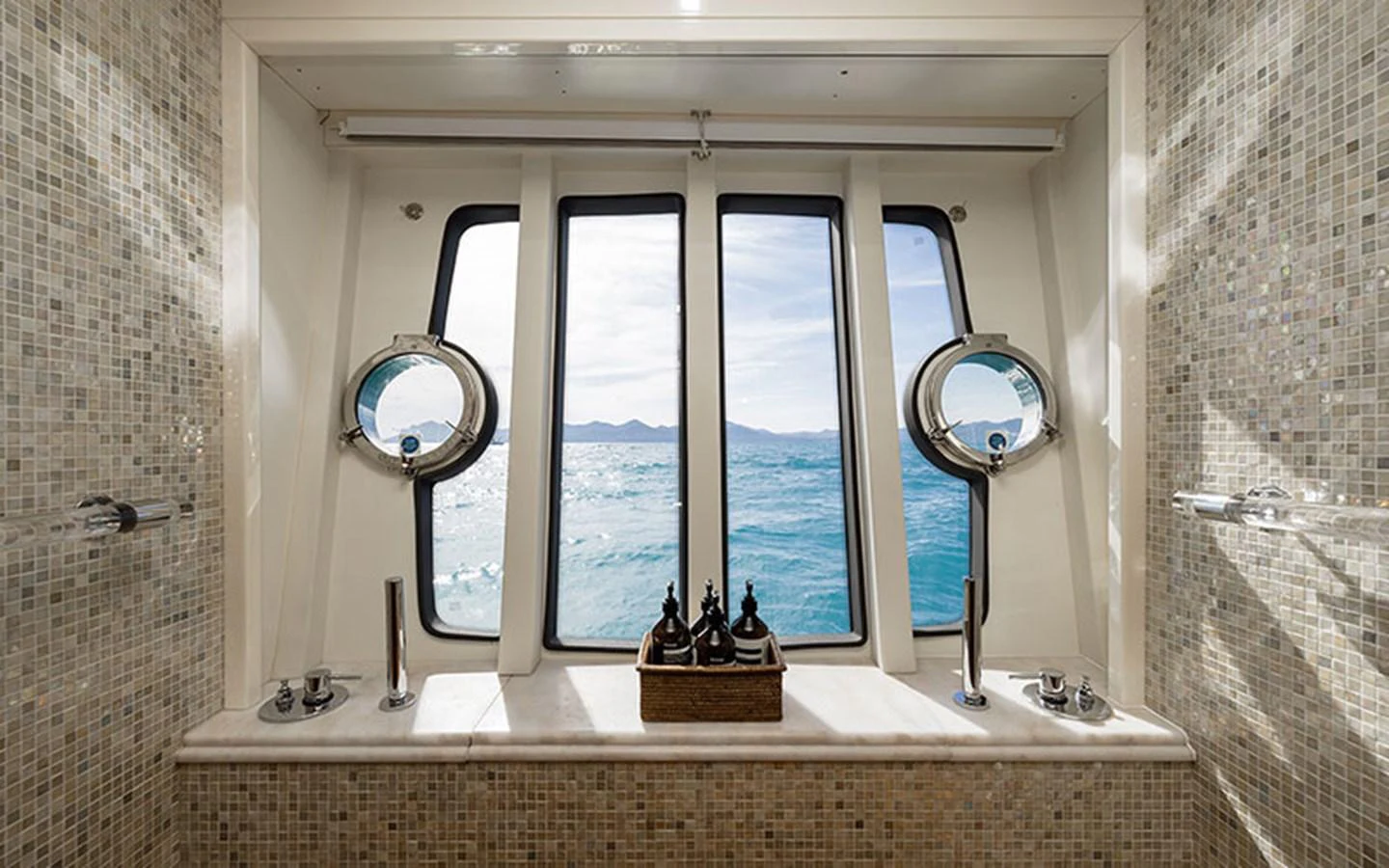 A luxurious yacht bathroom with a stunning ocean view through large windows. aboard ONYX Yacht for Sale
