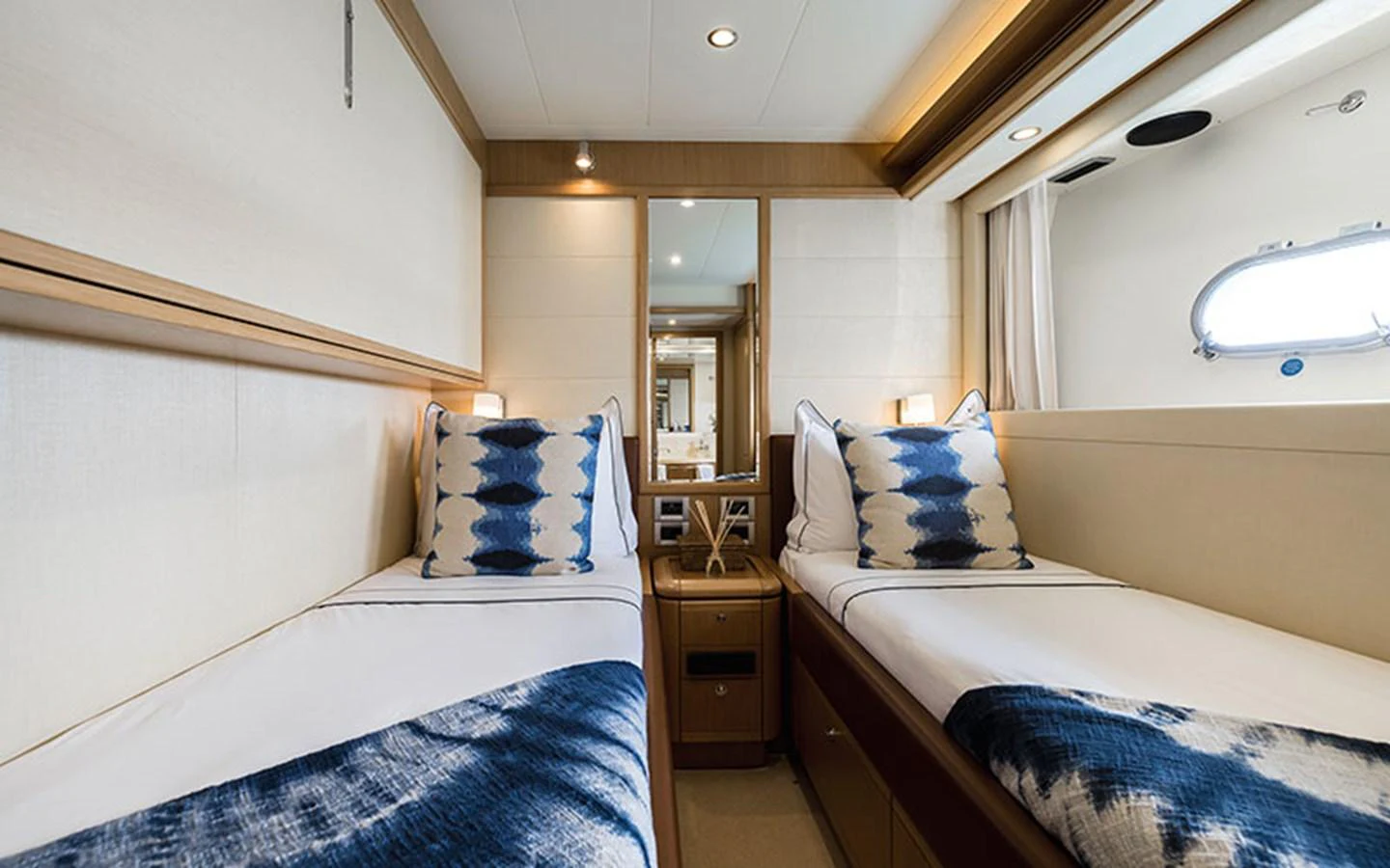The twin stateroom features two single beds with elegant bedding and a large window for natural light. aboard ONYX Yacht for Sale