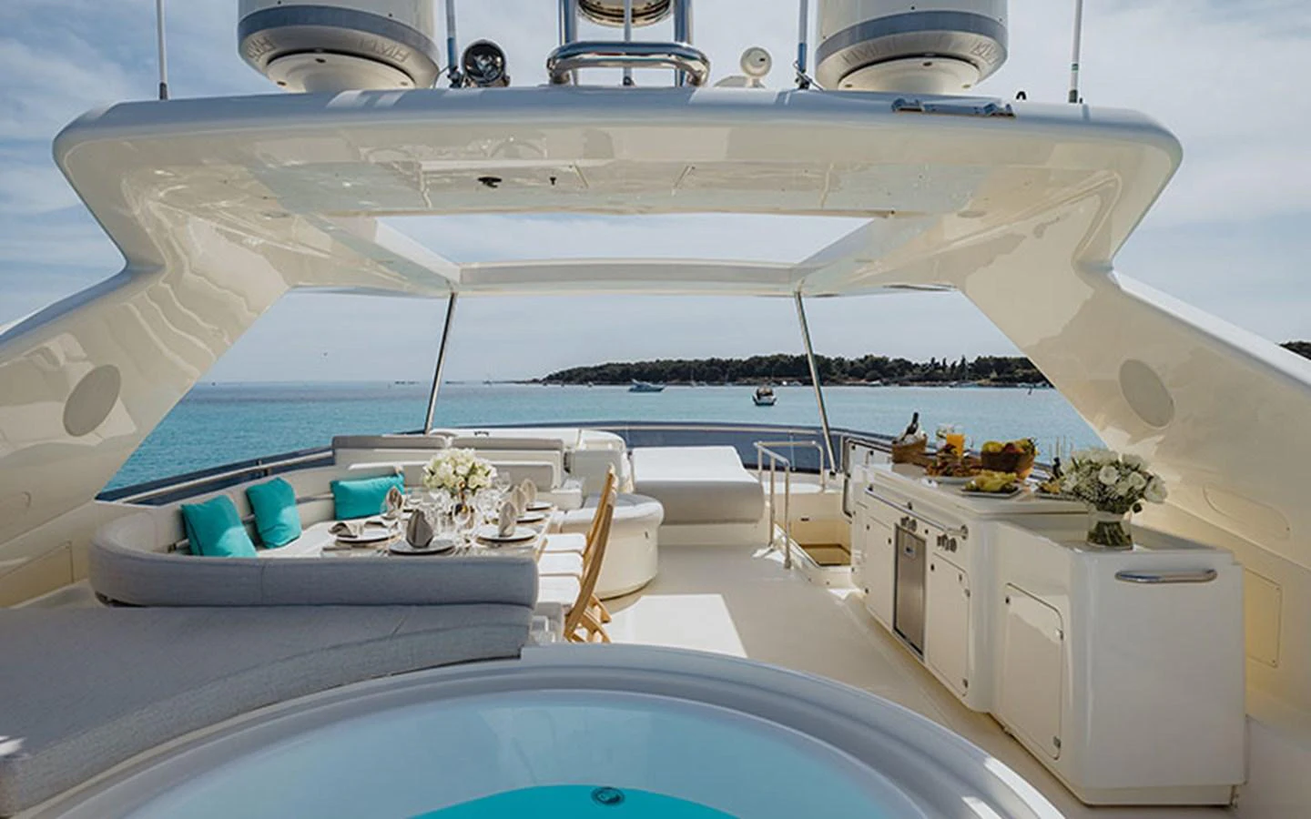 The flybridge offers a luxurious outdoor living space with comfortable seating, a dining area, and a well-equipped bar. aboard ONYX Yacht for Sale