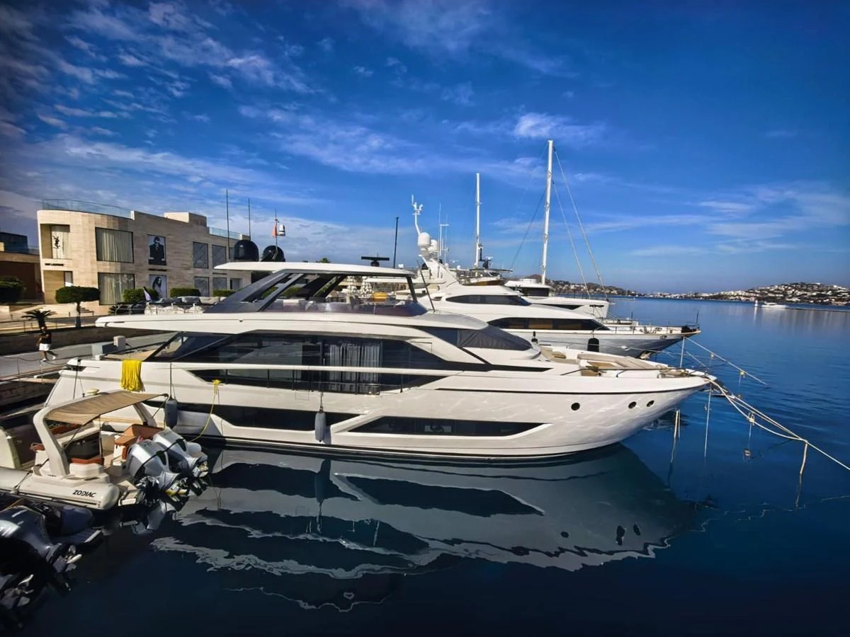A sleek and modern yacht is docked at a marina under a clear blue sky. aboard TBN 860 Yacht for Sale