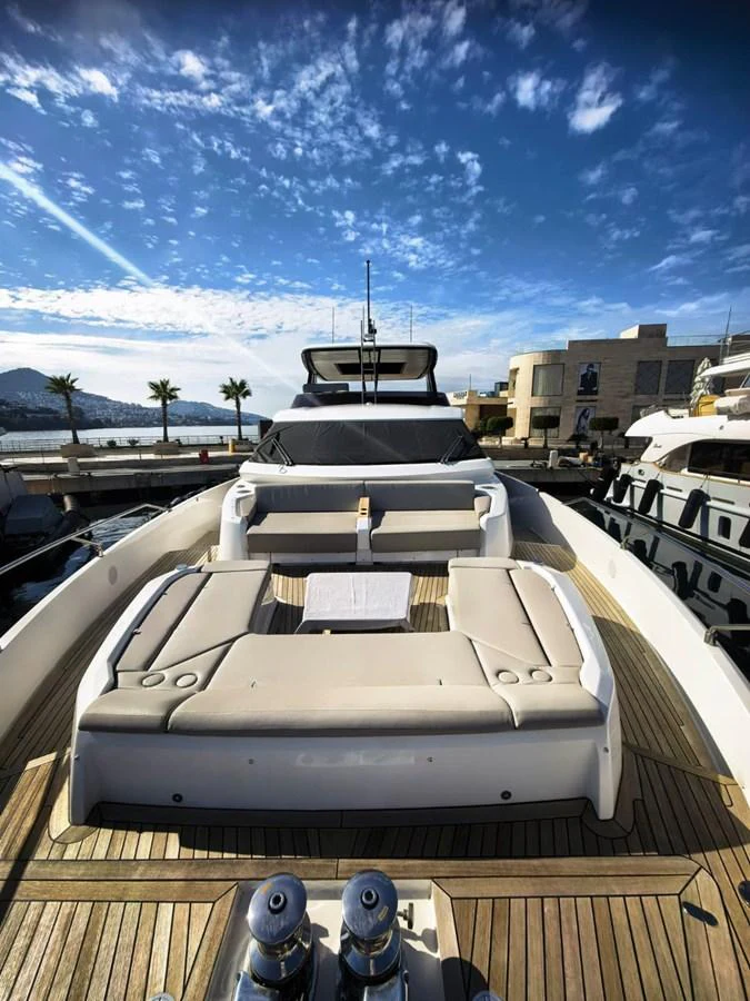 The foredeck of this yacht features a spacious sunbathing area with plush cushions and a stunning view of the marina. aboard TBN 860 Yacht for Sale