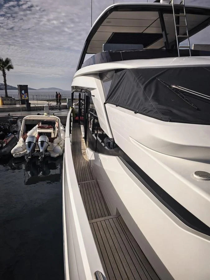 A sleek yacht docked at the marina, showcasing its modern design and spacious deck. aboard TBN 860 Yacht for Sale