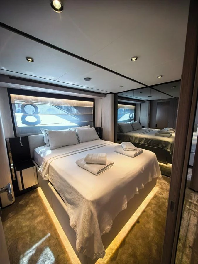 A luxurious stateroom featuring a plush bed with elegant linens and ambient lighting. aboard TBN 860 Yacht for Sale