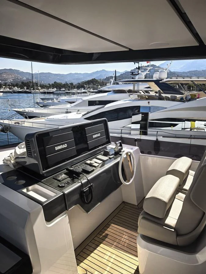 The helm station features advanced navigation equipment and comfortable seating. aboard TBN 860 Yacht for Sale