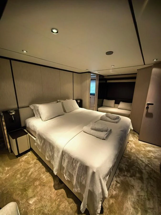 The stateroom features a luxurious double bed with plush linens and a cozy ambiance. aboard TBN 860 Yacht for Sale