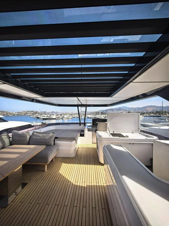 The aft deck features a spacious seating area with a retractable roof, offering a perfect blend of comfort and open-air luxury. aboard TBN 860 Yacht for Sale