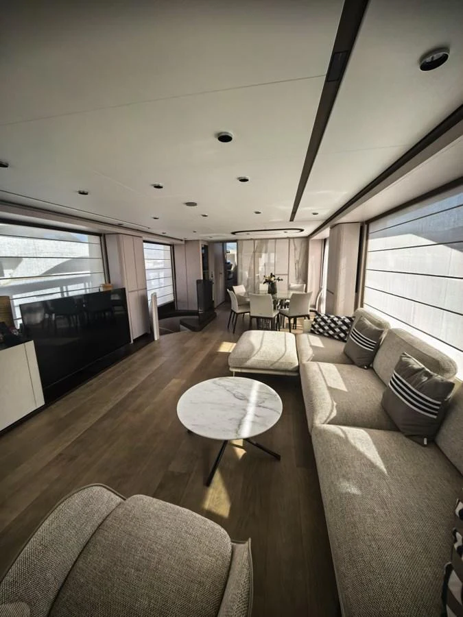 The yacht's salon features elegant seating and a modern design with ample natural light. aboard TBN 860 Yacht for Sale