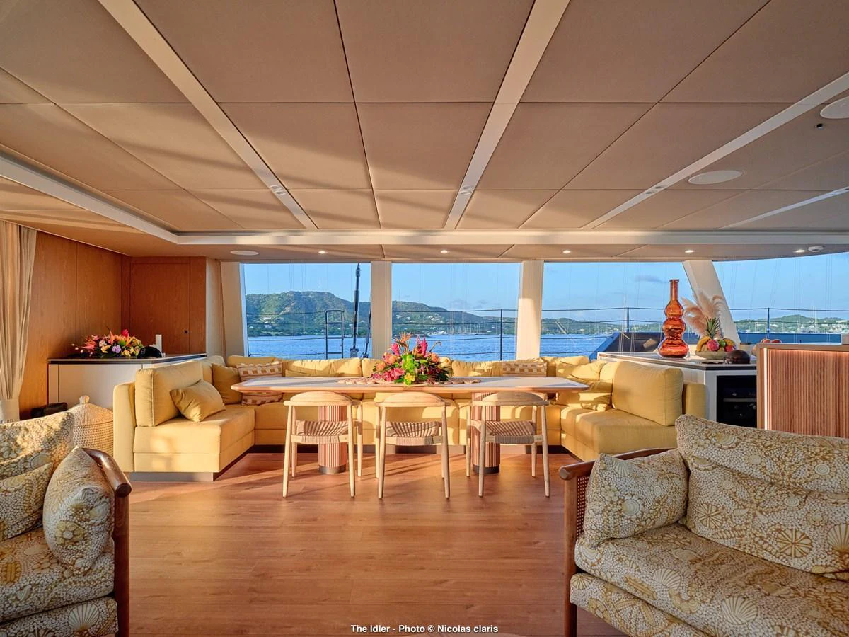 The salon offers a spacious and inviting area with panoramic views and elegant furnishings. aboard THE IDLER Yacht for Sale