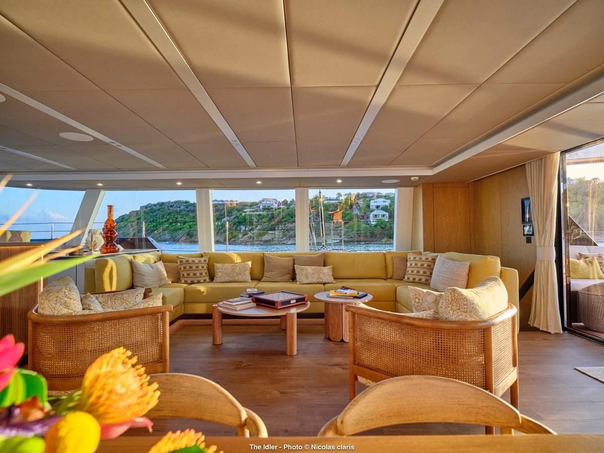 The salon features a spacious and inviting seating area with panoramic views. aboard THE IDLER Yacht for Sale