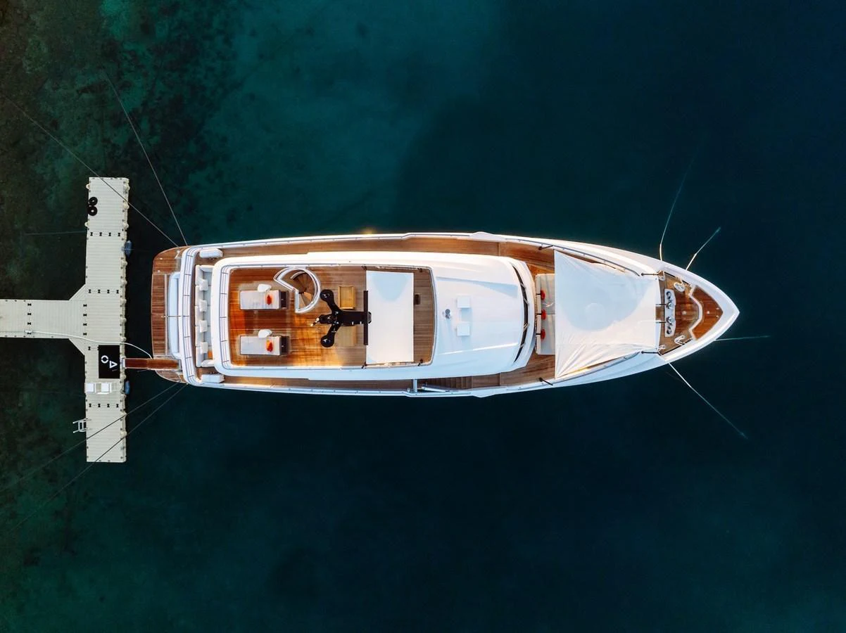Aerial view of a luxurious yacht docked at a serene marina. aboard AT ONE Yacht for Sale