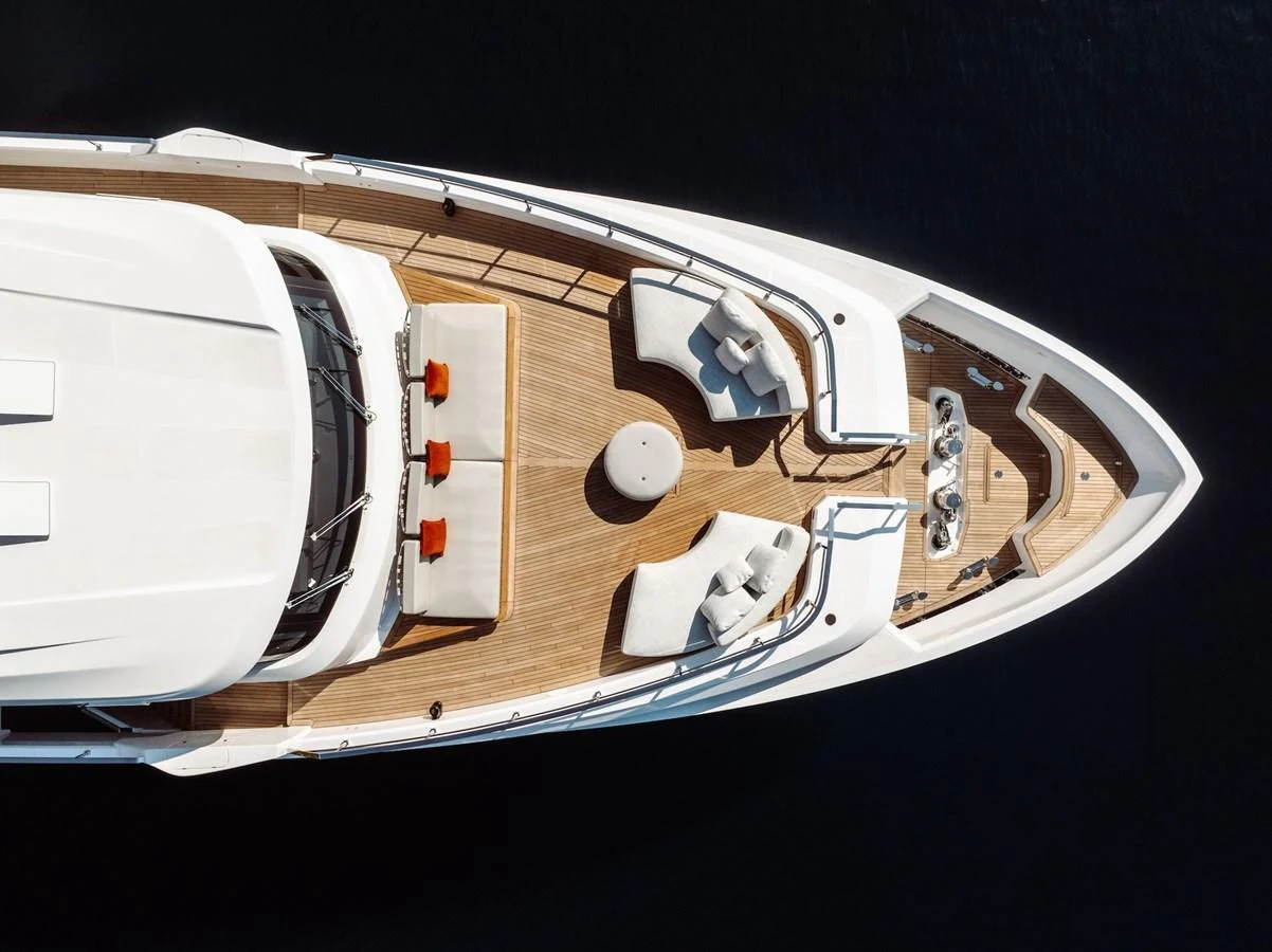 The foredeck features elegant seating areas with plush cushions and a central table, perfect for relaxation and socializing. aboard AT ONE Yacht for Sale