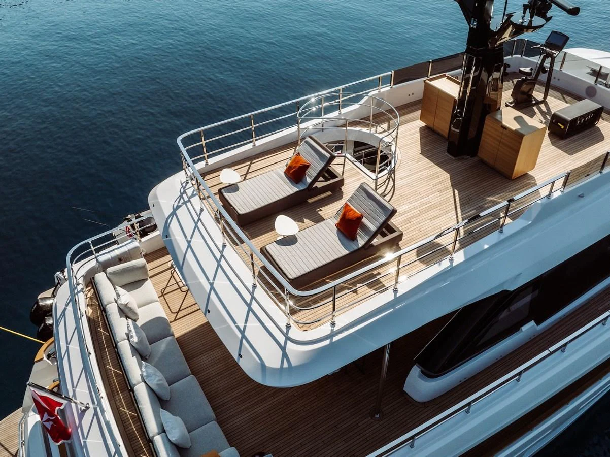 The sundeck offers a luxurious space with sun loungers and a stunning view over the water. aboard AT ONE Yacht for Sale