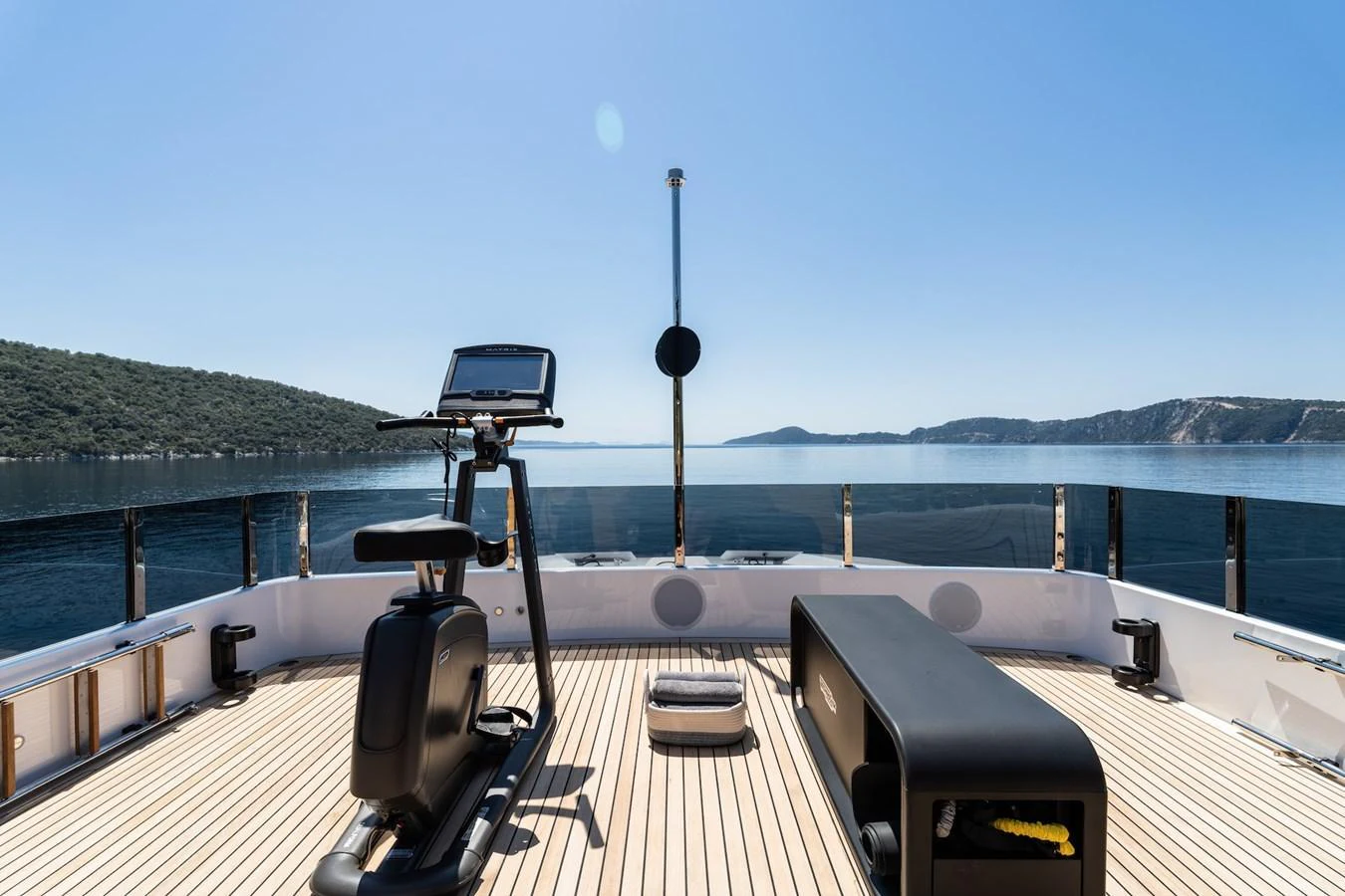 The sundeck features a fitness area with stunning sea views. aboard AT ONE Yacht for Sale