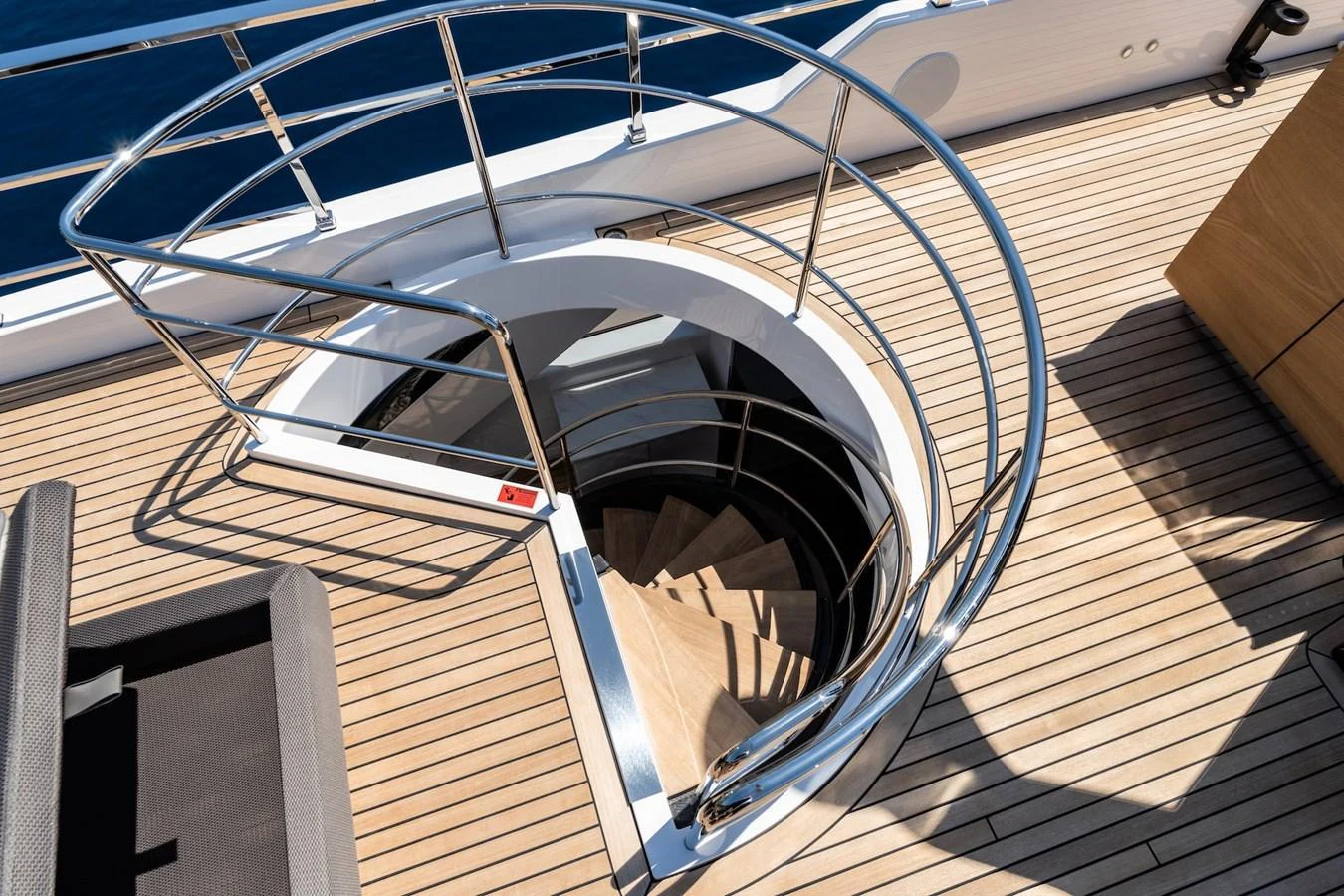 A sleek spiral staircase leads from the deck to the lower levels of the yacht. aboard AT ONE Yacht for Sale