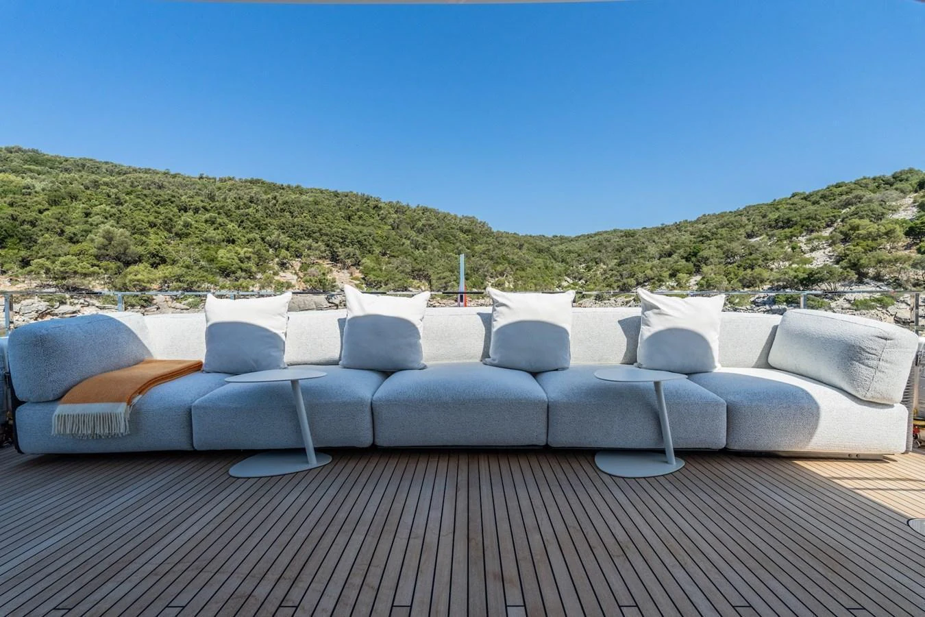 The aft deck features a spacious and comfortable seating area with a stunning view of the surrounding landscape. aboard AT ONE Yacht for Sale