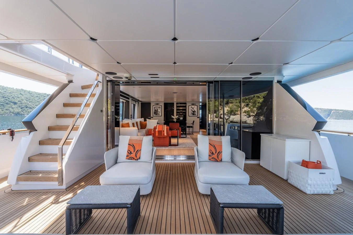 The aft deck features comfortable seating with a view into the stylish interior lounge area. aboard AT ONE Yacht for Sale