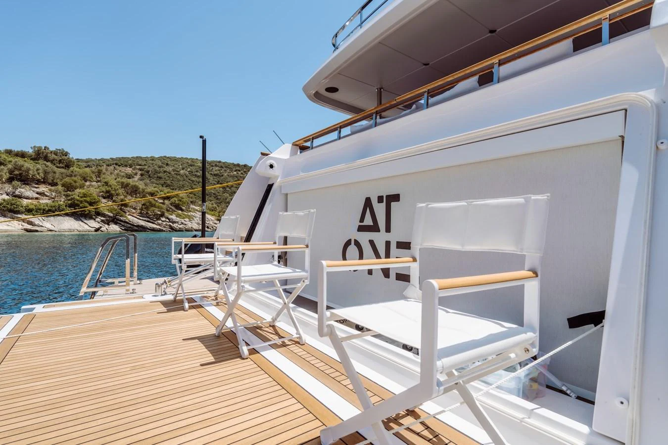 The aft deck features comfortable seating with a scenic view of the water. aboard AT ONE Yacht for Sale
