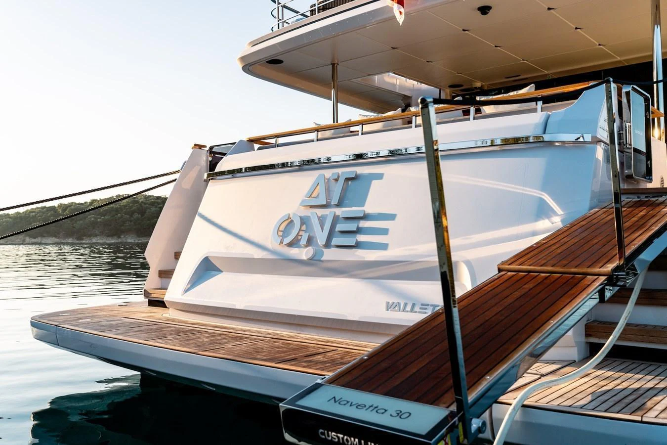 The stern of the yacht features a spacious swim platform and elegant design details. aboard AT ONE Yacht for Sale