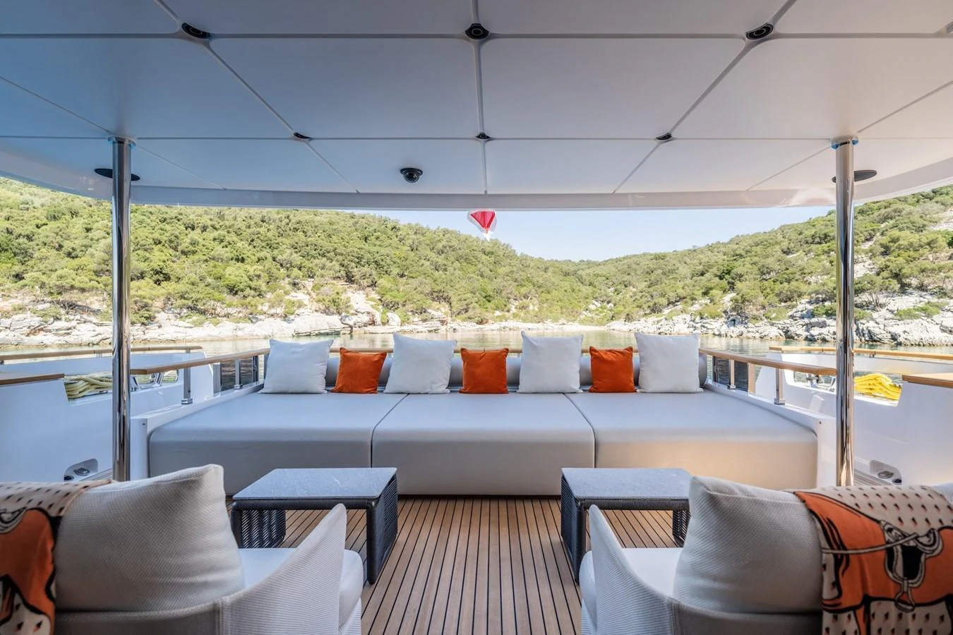 The aft deck offers a spacious and comfortable seating area with scenic views of the surrounding landscape. aboard AT ONE Yacht for Sale