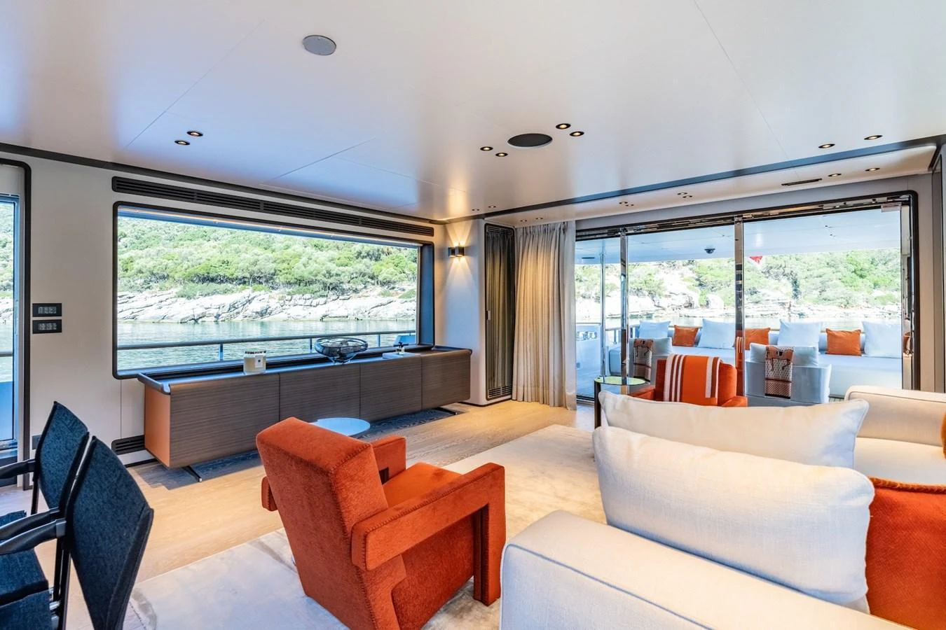The salon offers a spacious and modern interior with large windows providing stunning views. aboard AT ONE Yacht for Sale