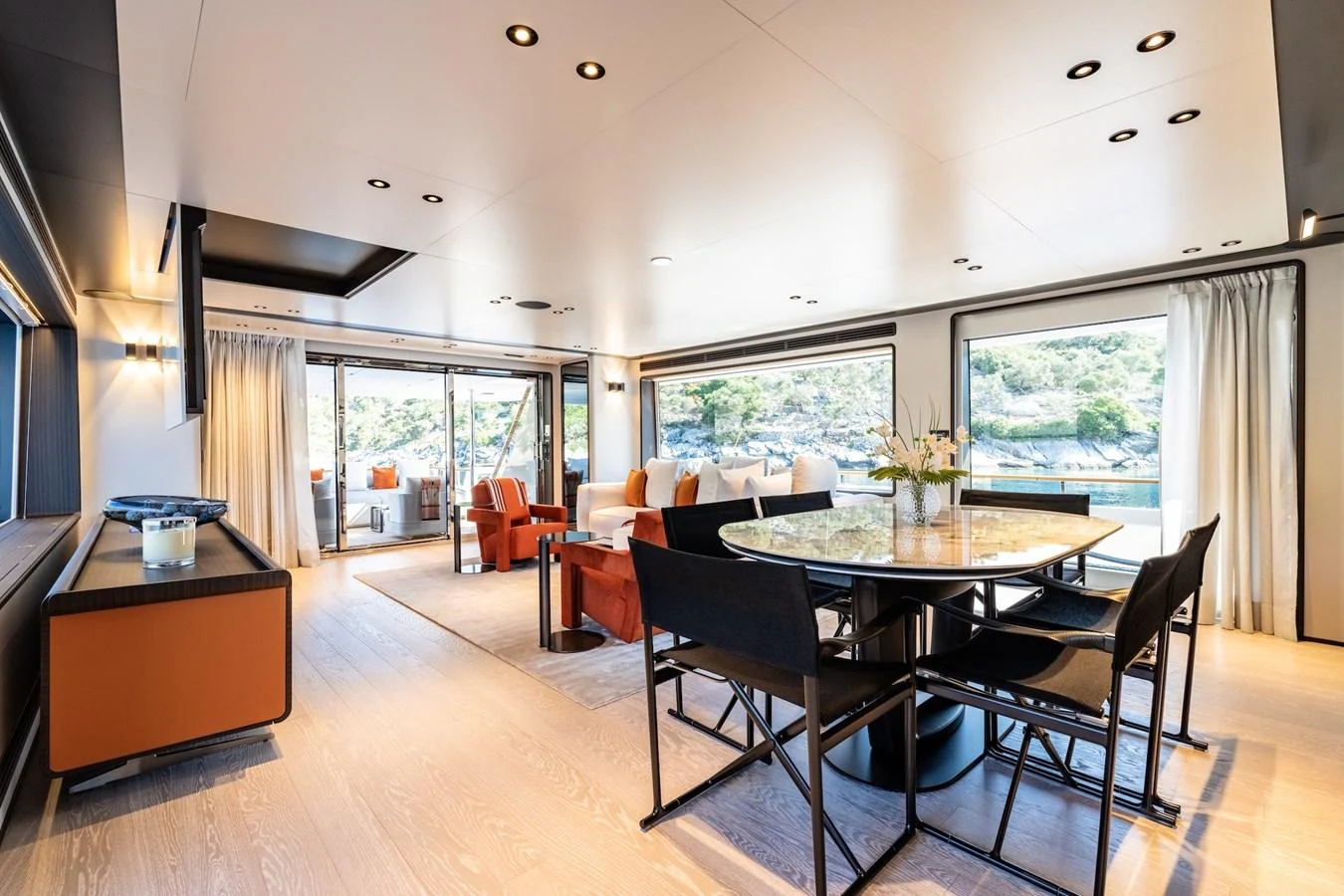 The spacious salon features elegant furnishings and large windows offering stunning views. aboard AT ONE Yacht for Sale