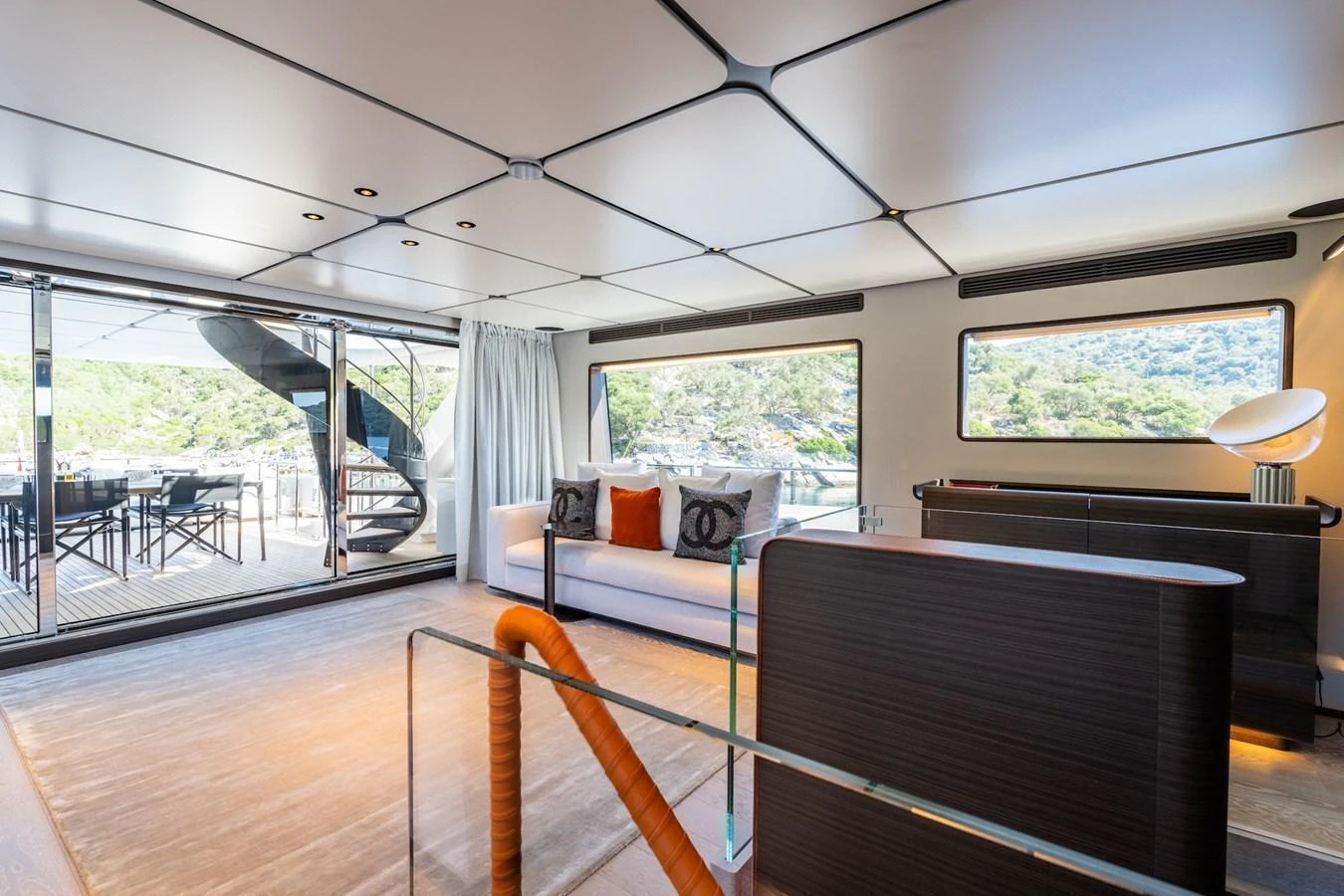 The yacht's salon features modern furnishings and large windows, creating a bright and inviting space. aboard AT ONE Yacht for Sale