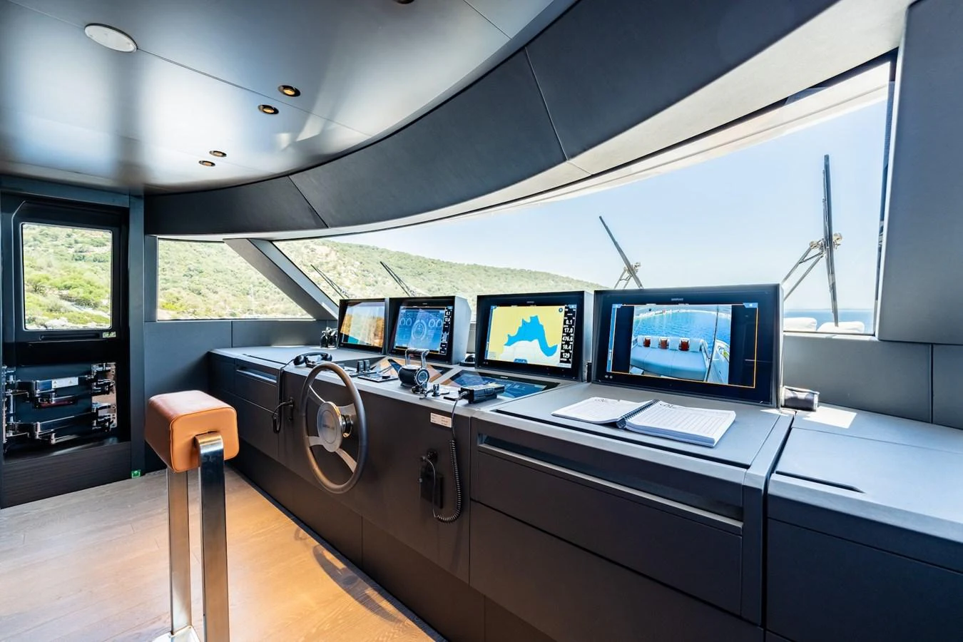 The helm station features advanced navigation equipment and panoramic windows for optimal visibility. aboard AT ONE Yacht for Sale