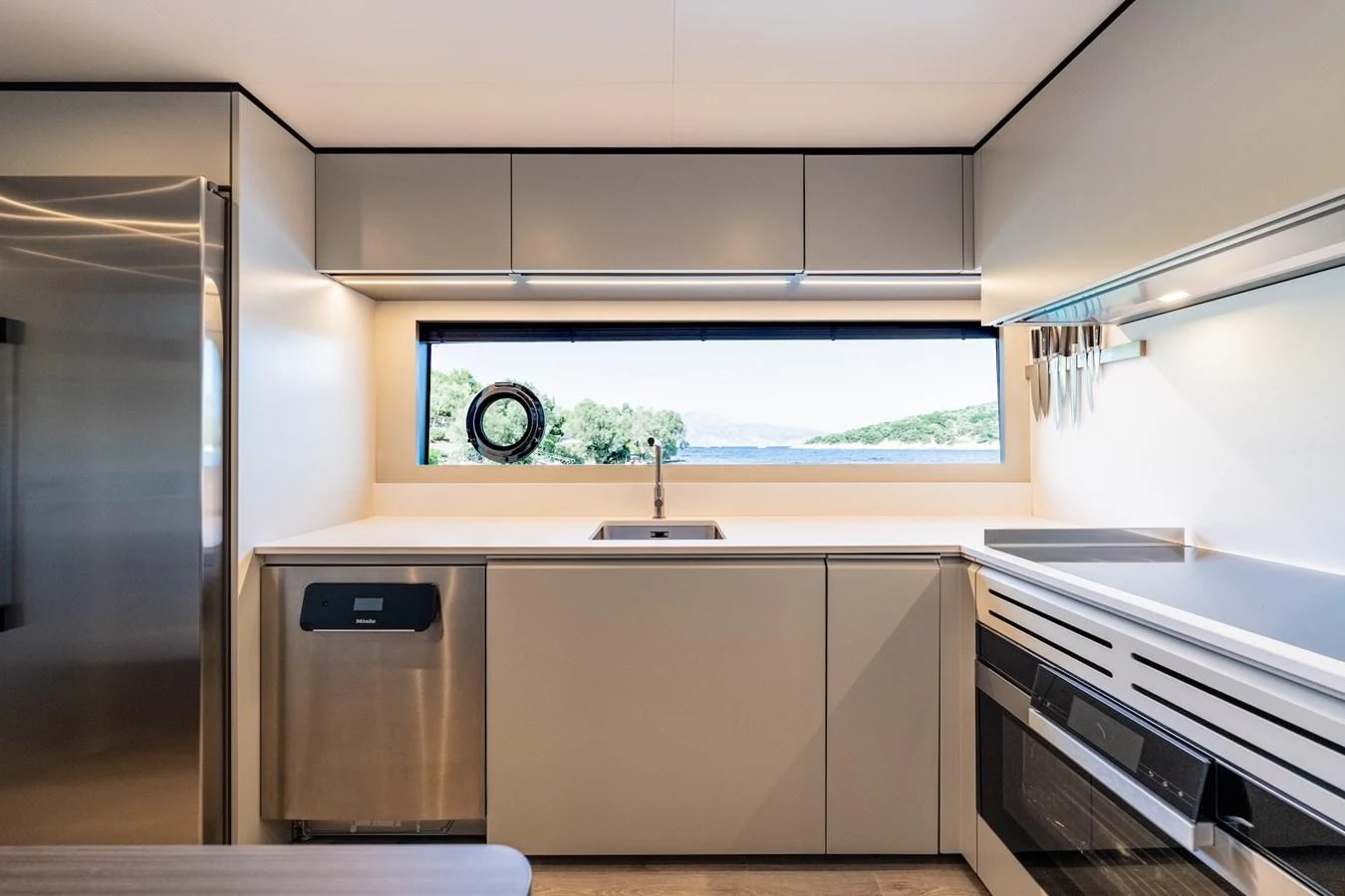 The yacht's galley is modern and well-equipped, featuring sleek cabinetry and high-end appliances. aboard AT ONE Yacht for Sale