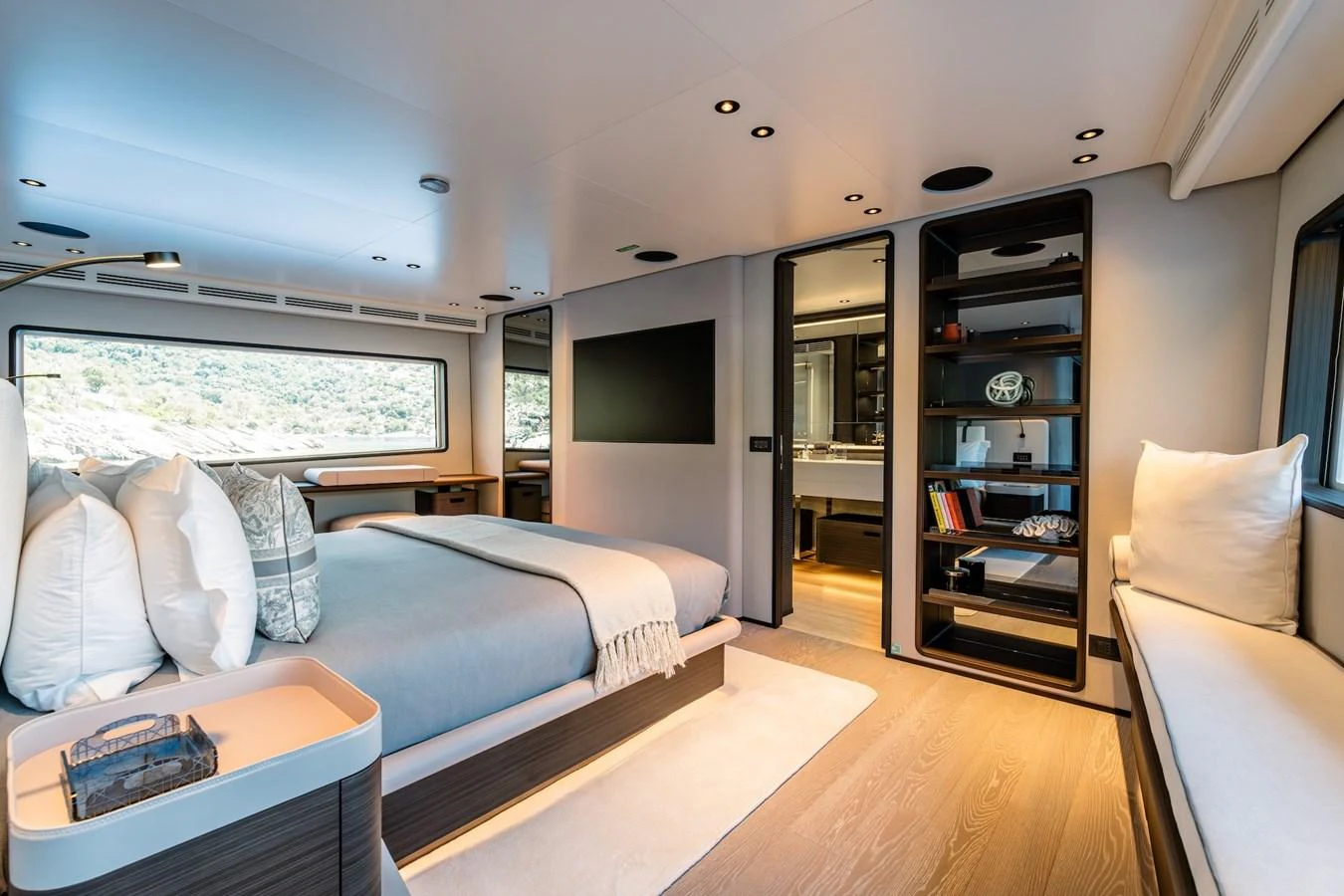 The master stateroom features a luxurious bed, ample natural light, and elegant furnishings. aboard AT ONE Yacht for Sale
