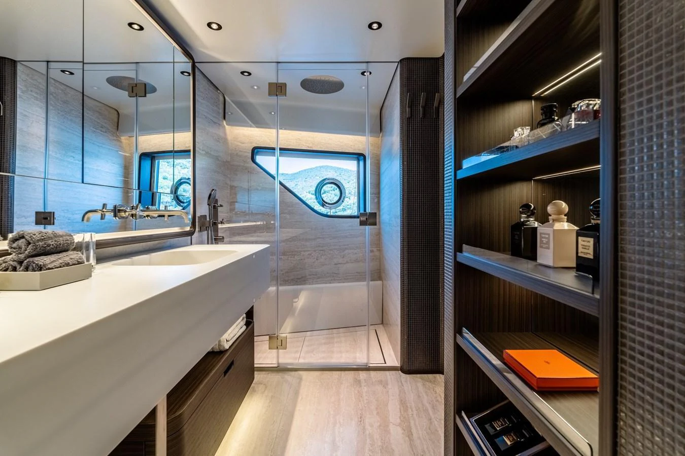 The yacht's bathroom features a sleek design with modern fixtures and ample storage space. aboard AT ONE Yacht for Sale