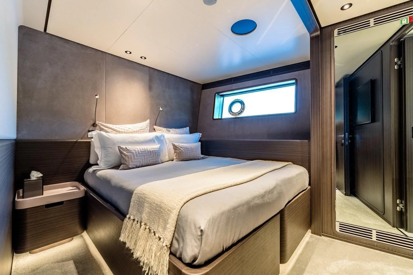 A cozy and well-appointed stateroom with a large bed and modern decor. aboard AT ONE Yacht for Sale