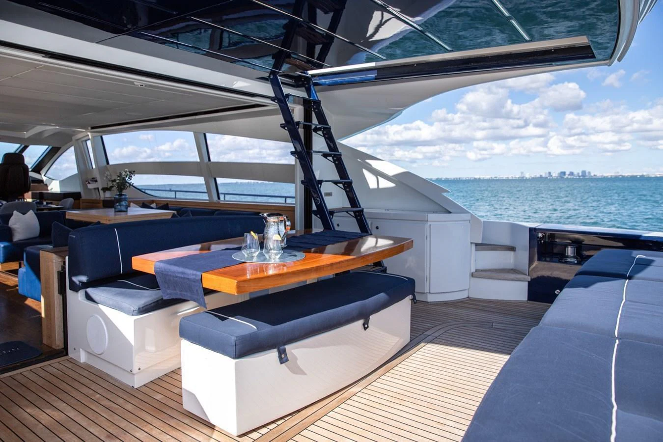 The aft deck features a stylish dining area with panoramic ocean views. aboard DOROTHY ANN Yacht for Sale