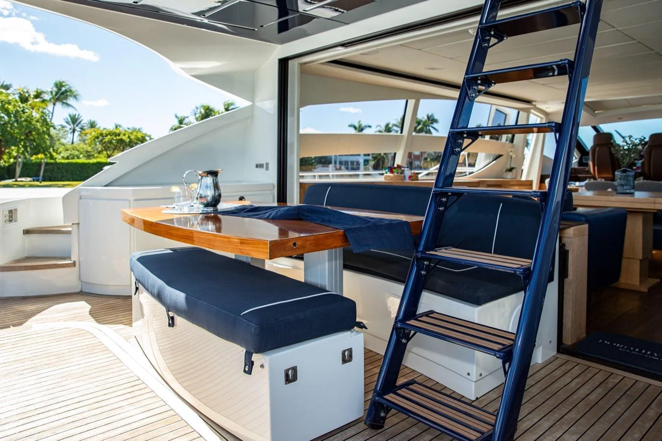 The aft deck features a comfortable seating area with a wooden table and easy access to the interior. aboard DOROTHY ANN Yacht for Sale