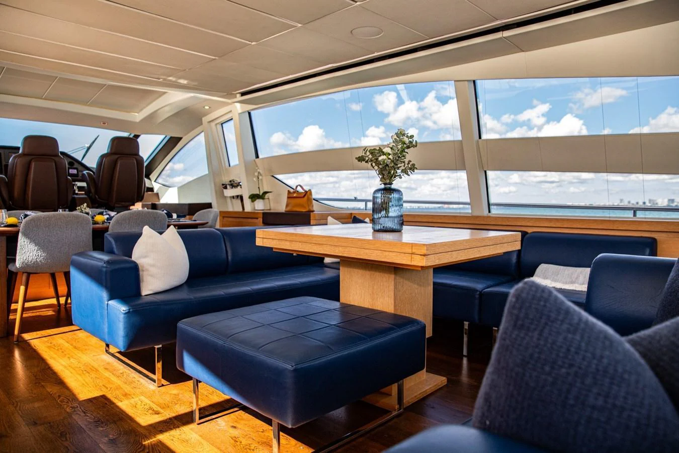 The yacht's salon features luxurious seating with panoramic windows offering stunning ocean views. aboard DOROTHY ANN Yacht for Sale