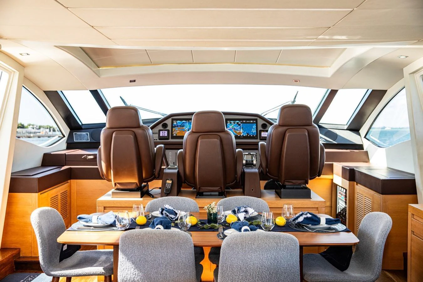 The helm area features luxurious seating and a well-appointed dining table, offering a blend of functionality and comfort. aboard DOROTHY ANN Yacht for Sale