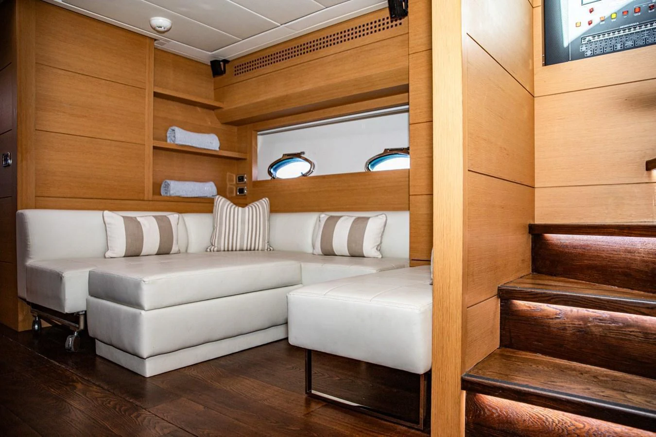 The salon features a cozy seating area with plush white cushions and wooden accents. aboard DOROTHY ANN Yacht for Sale
