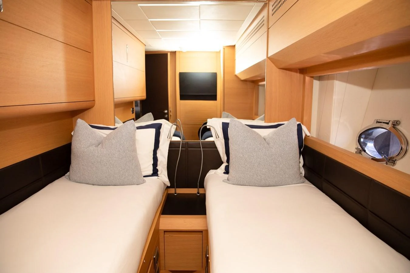 The twin cabin features two comfortable beds with plush pillows and a modern, cozy design. aboard DOROTHY ANN Yacht for Sale