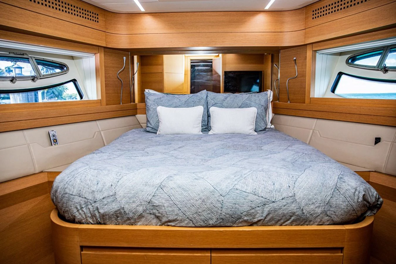 The stateroom features a plush bed with ample natural light from surrounding windows. aboard DOROTHY ANN Yacht for Sale