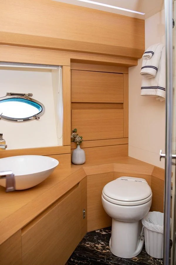 A well-appointed yacht bathroom featuring modern fixtures and elegant wood finishes. aboard DOROTHY ANN Yacht for Sale