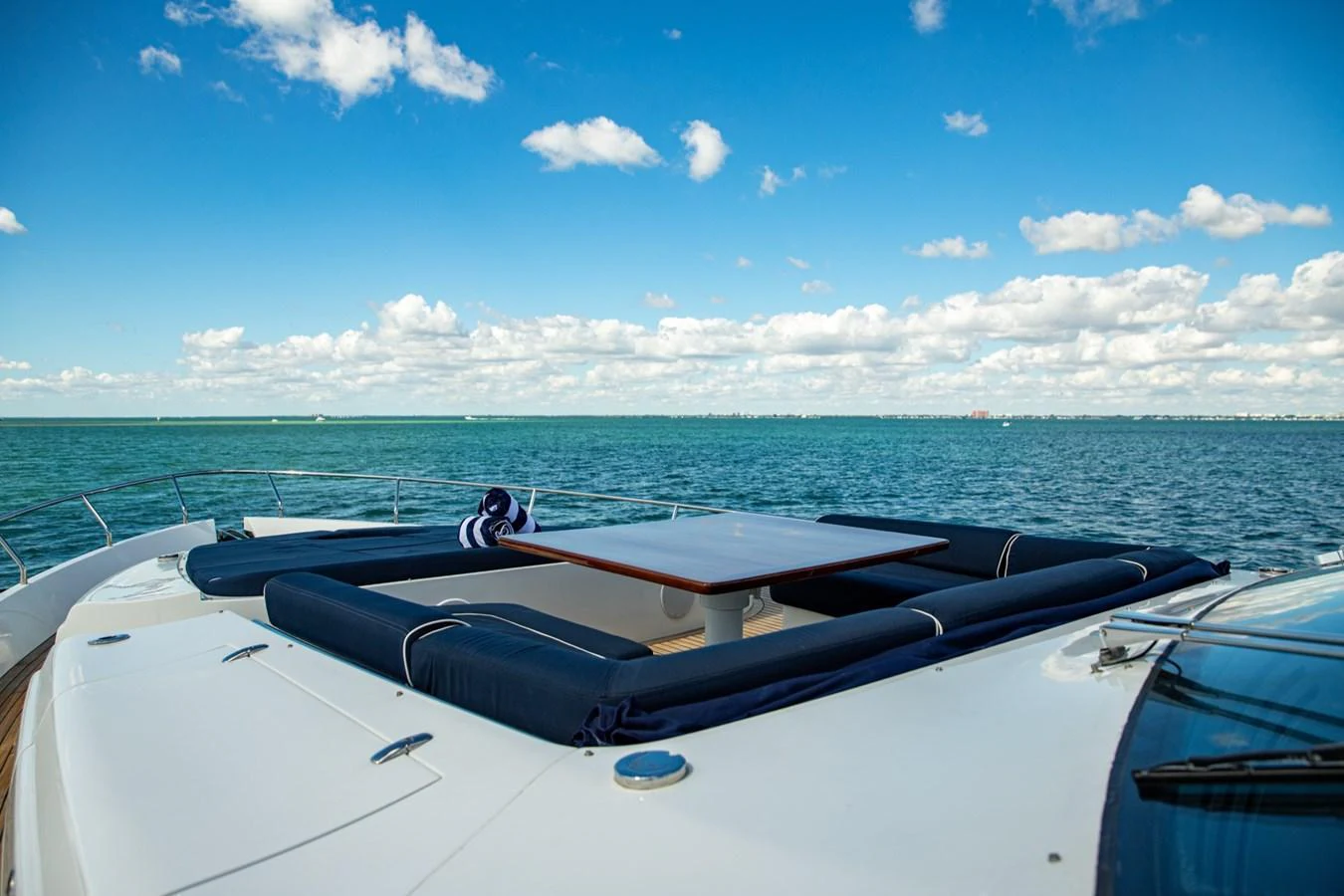 The foredeck features a luxurious sunbathing area with comfortable cushions and a central table, perfect for relaxation. aboard DOROTHY ANN Yacht for Sale