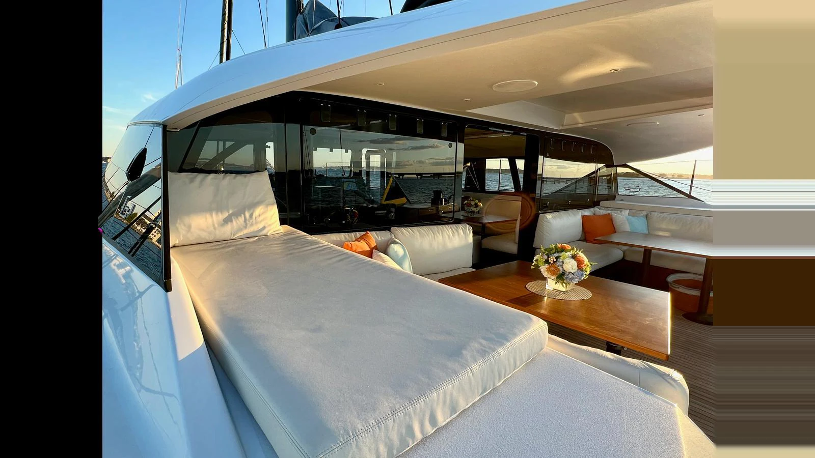 The aft deck features a luxurious lounging area with comfortable seating and a dining table, perfect for relaxation and socializing. aboard GUNBOAT 80 Yacht for Sale
