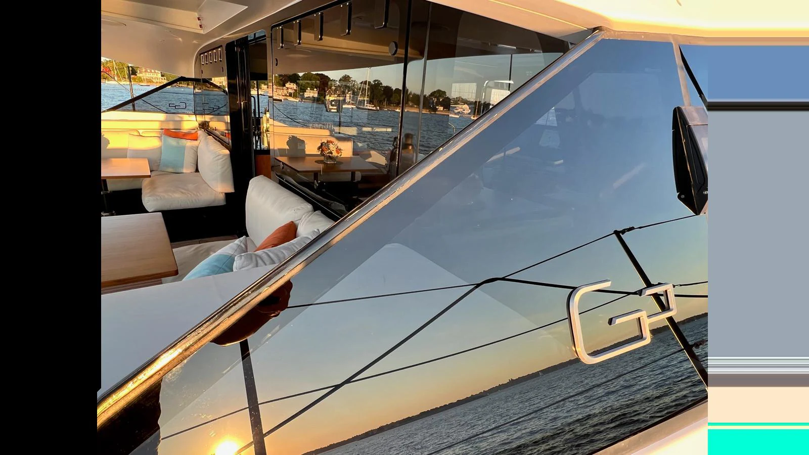 The yacht's sleek exterior features reflective windows and a glimpse of the luxurious interior seating area. aboard GUNBOAT 80 Yacht for Sale